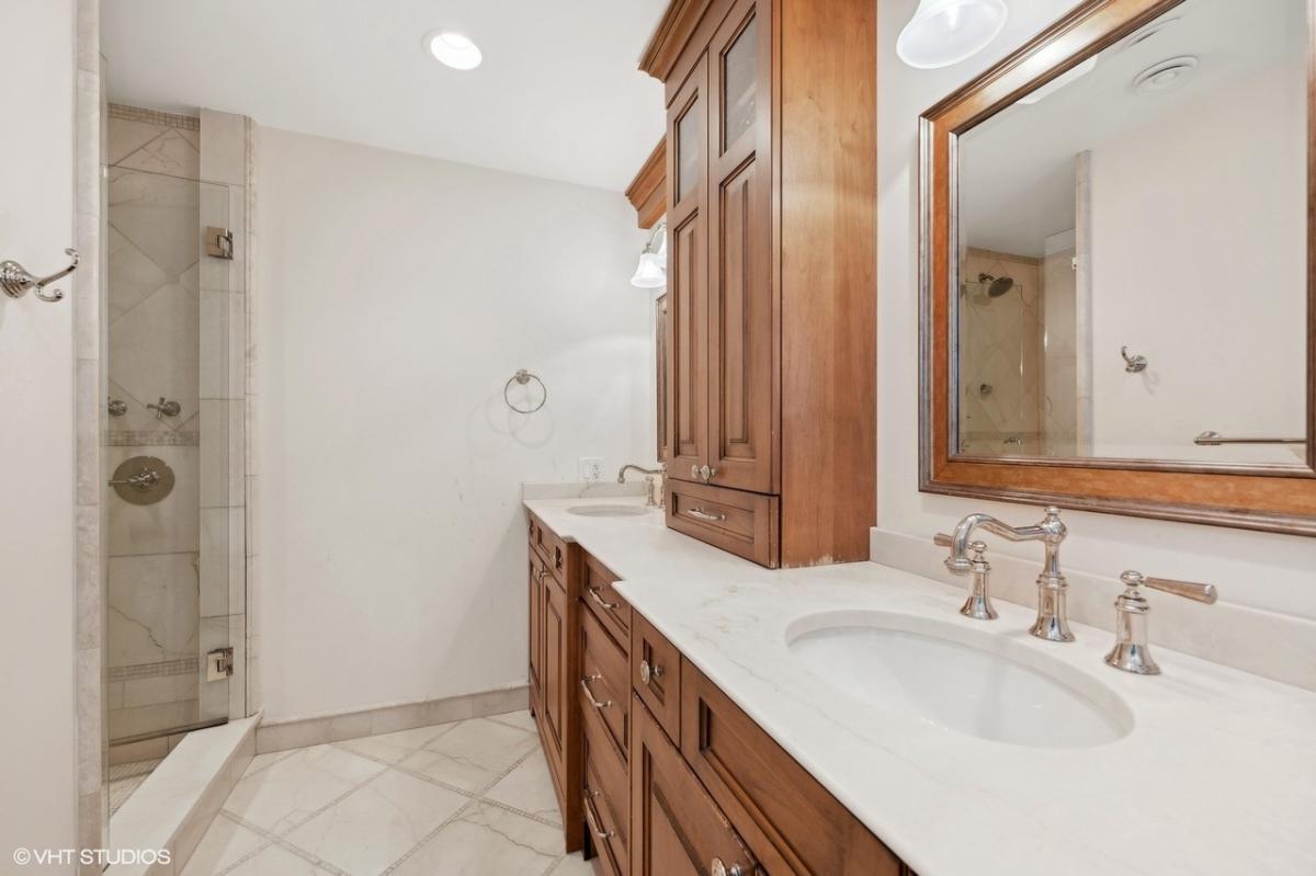Take a Look at the Warm Wood Cabinetry in This Elegant Bathroom