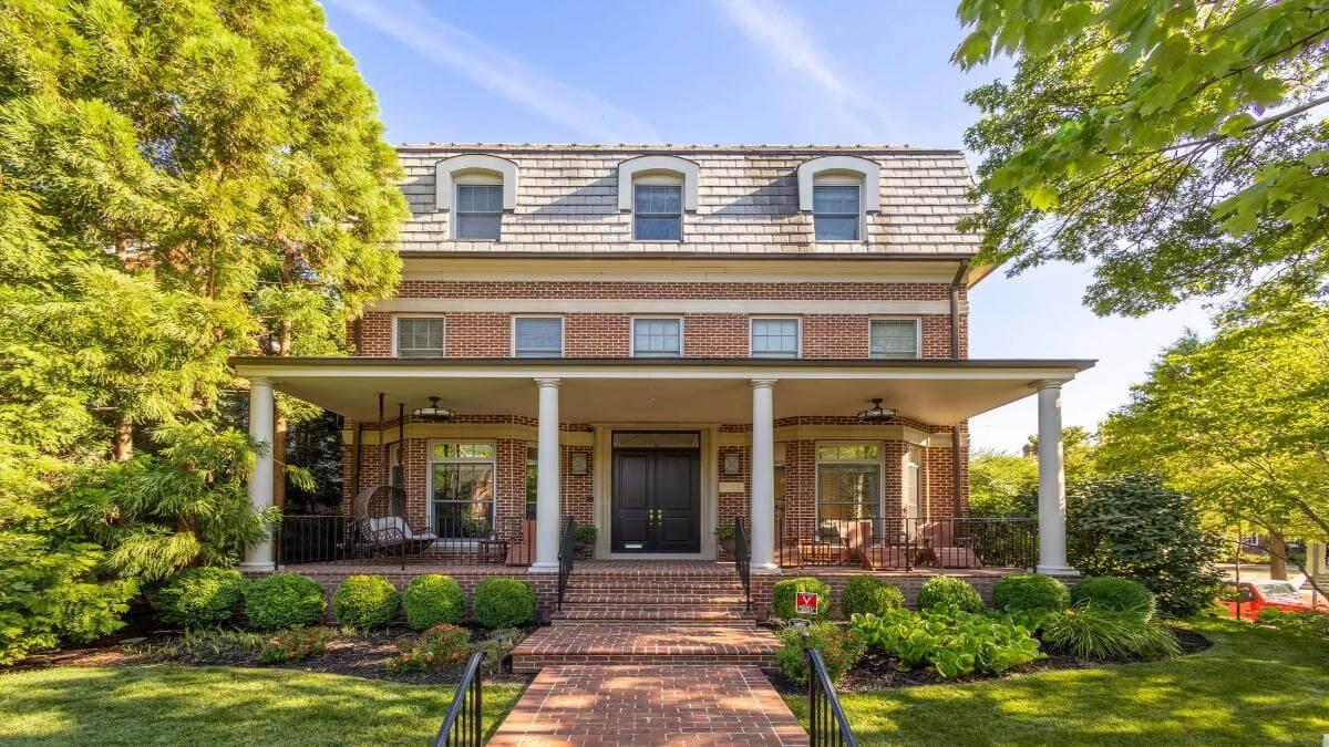 Classic Brick Facade with Inviting Porch Swing—A Timeless Entryway