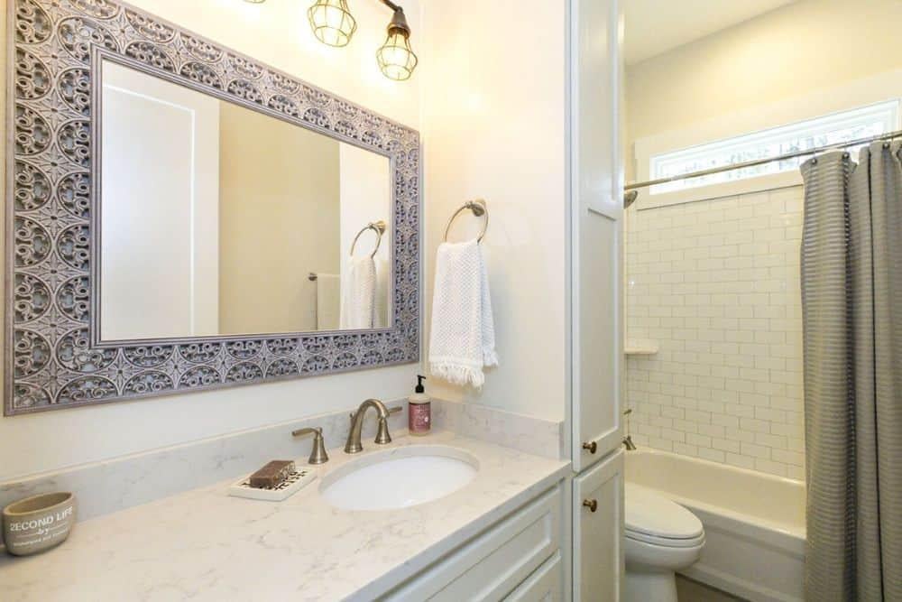 Appreciate the Intricate Mirror Frame in This Craftsman Bathroom