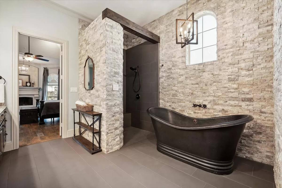 Wow, Look at the Textured Stone Walls and Vintage Tub in This Unique Bathroom