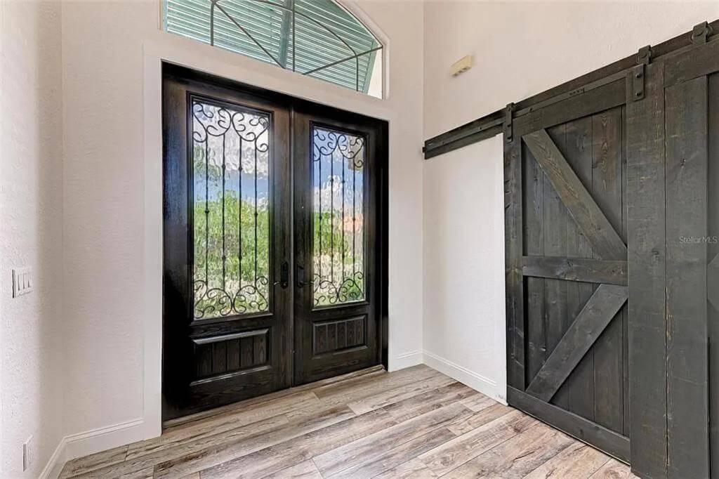 Rustic Entryway with Barn Door and Wrought Iron Accents