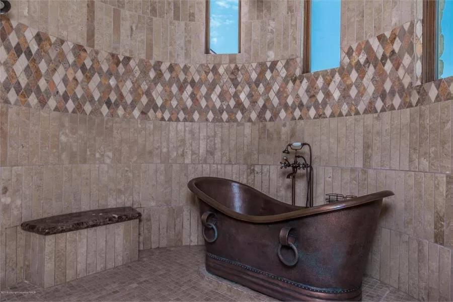 Admire the Unique Copper Tub in This Earthy Bathroom Alcove