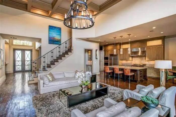 Living Room and Kitchen Harmony with Vaulted Ceilings and a Grand Iron Chandelier