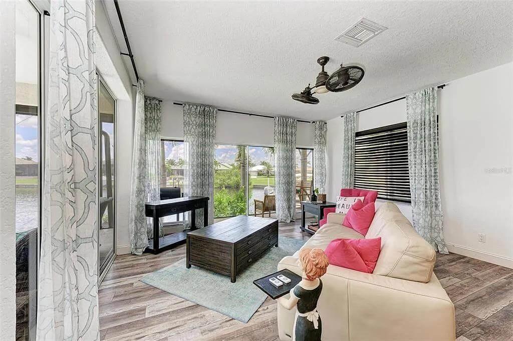 Sunny Living Room with Rustic Flooring and Eclectic Decor