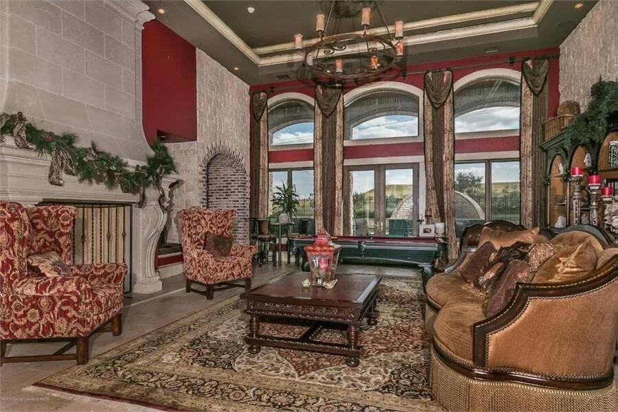 Appreciate the Rich Textures and Grand Fireplace in This Luxurious Living Room