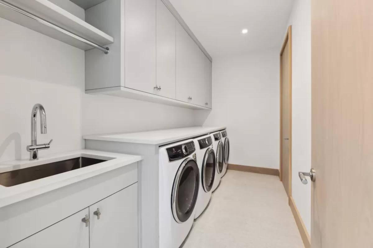 Sleek Laundry Room with Streamlined Cabinetry and Modern Appliances