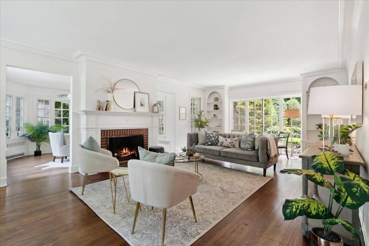 Elegant Living Room with Classic Fireplace and Light-Filled Views
