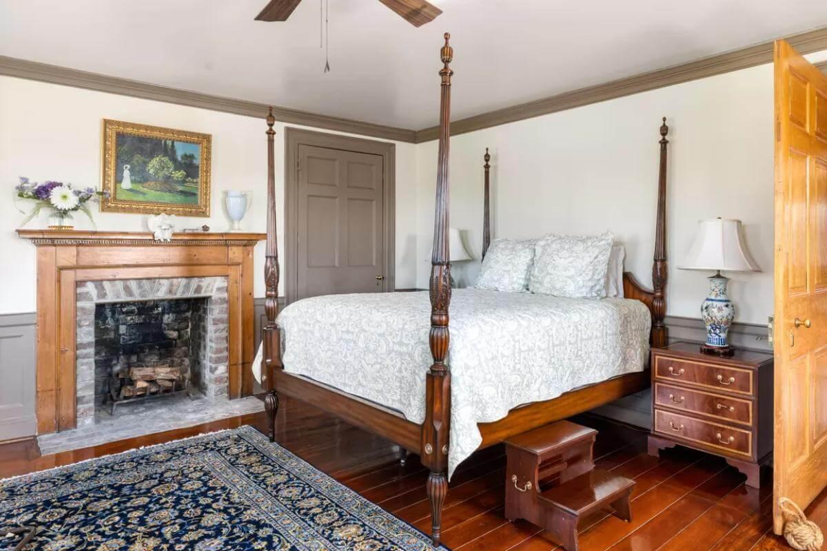 Classic Bedroom with a Timeless Four-Poster and Warm Fireplace