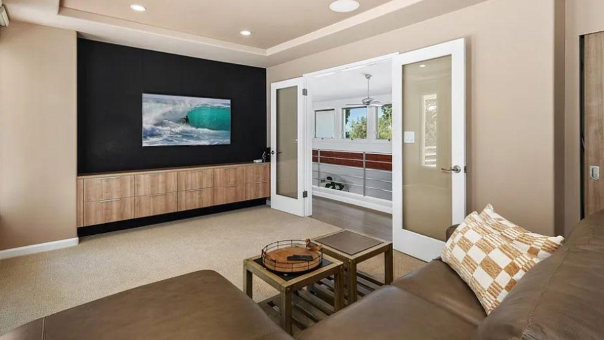 Relax in This Media Room with a Floating Cabinet and Cozy Seating