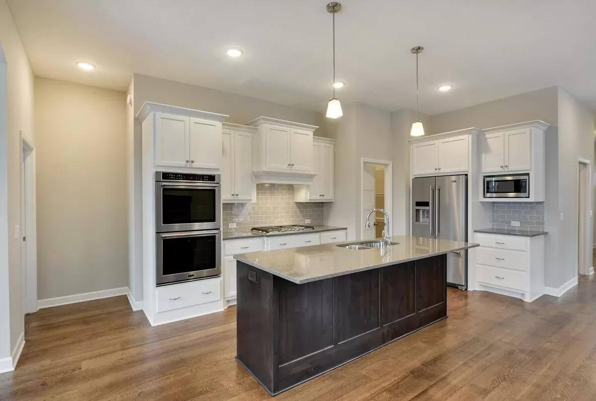 Check Out the Double Ovens and Chic Dark Island in This Craftsman Kitchen