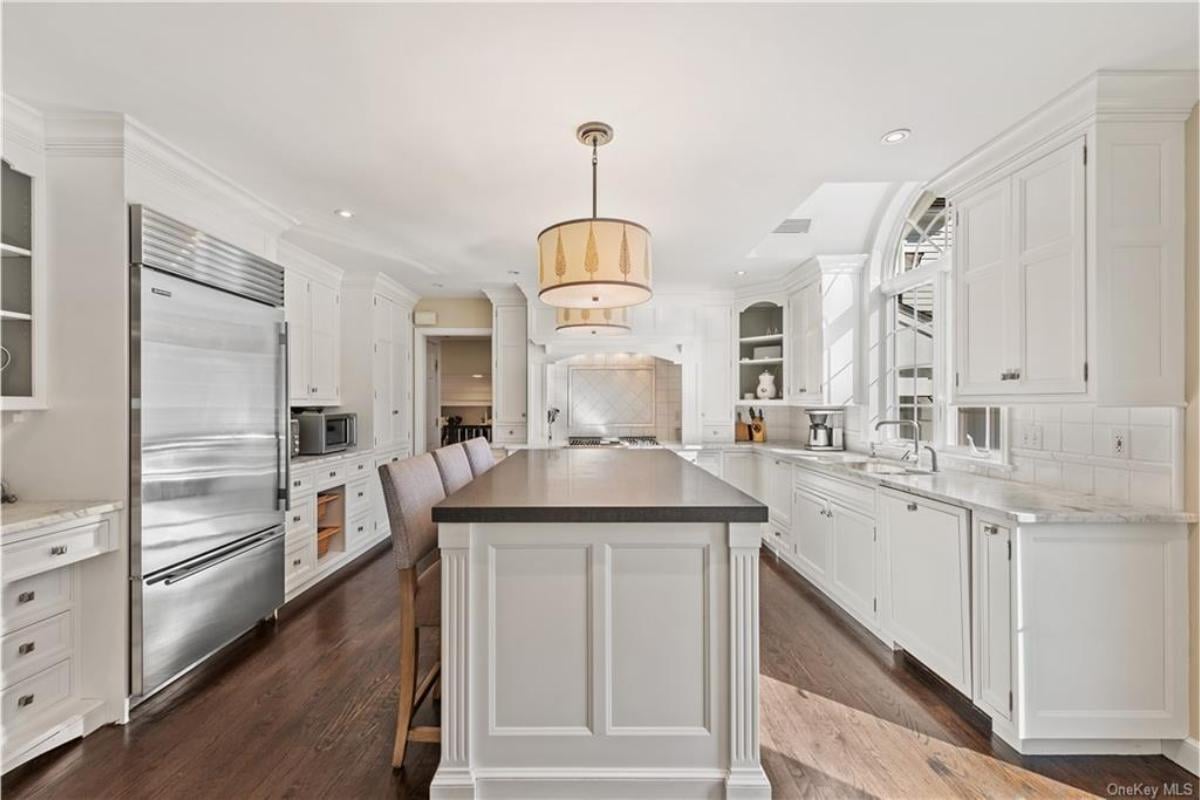 Notice the Grand Island Counter and Elegant Pendant Light in the Kitchen