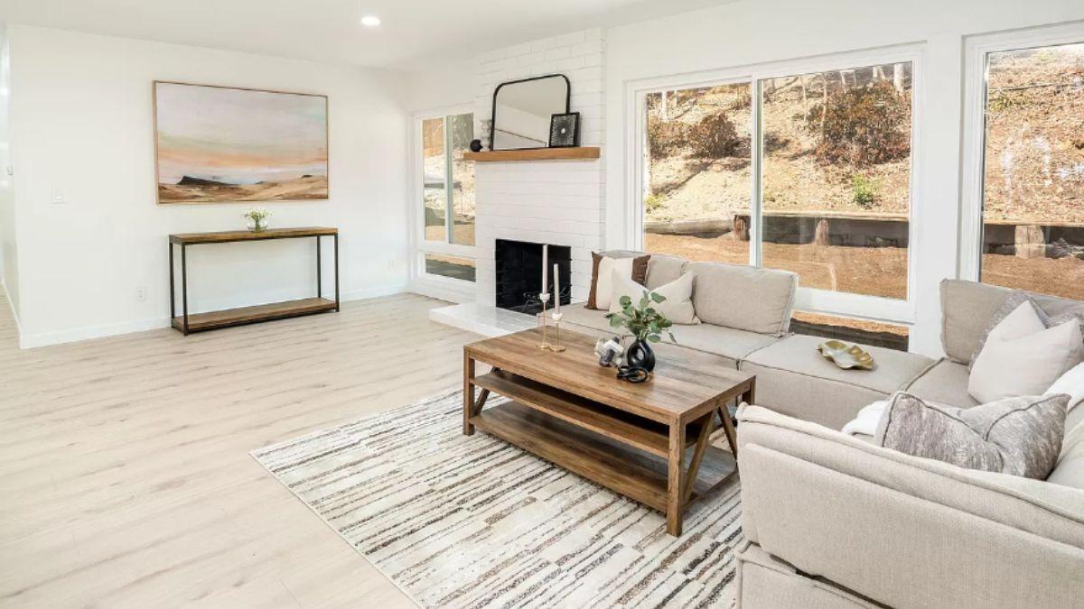 Bright Living Room with Wall of Windows and White Brick Fireplace