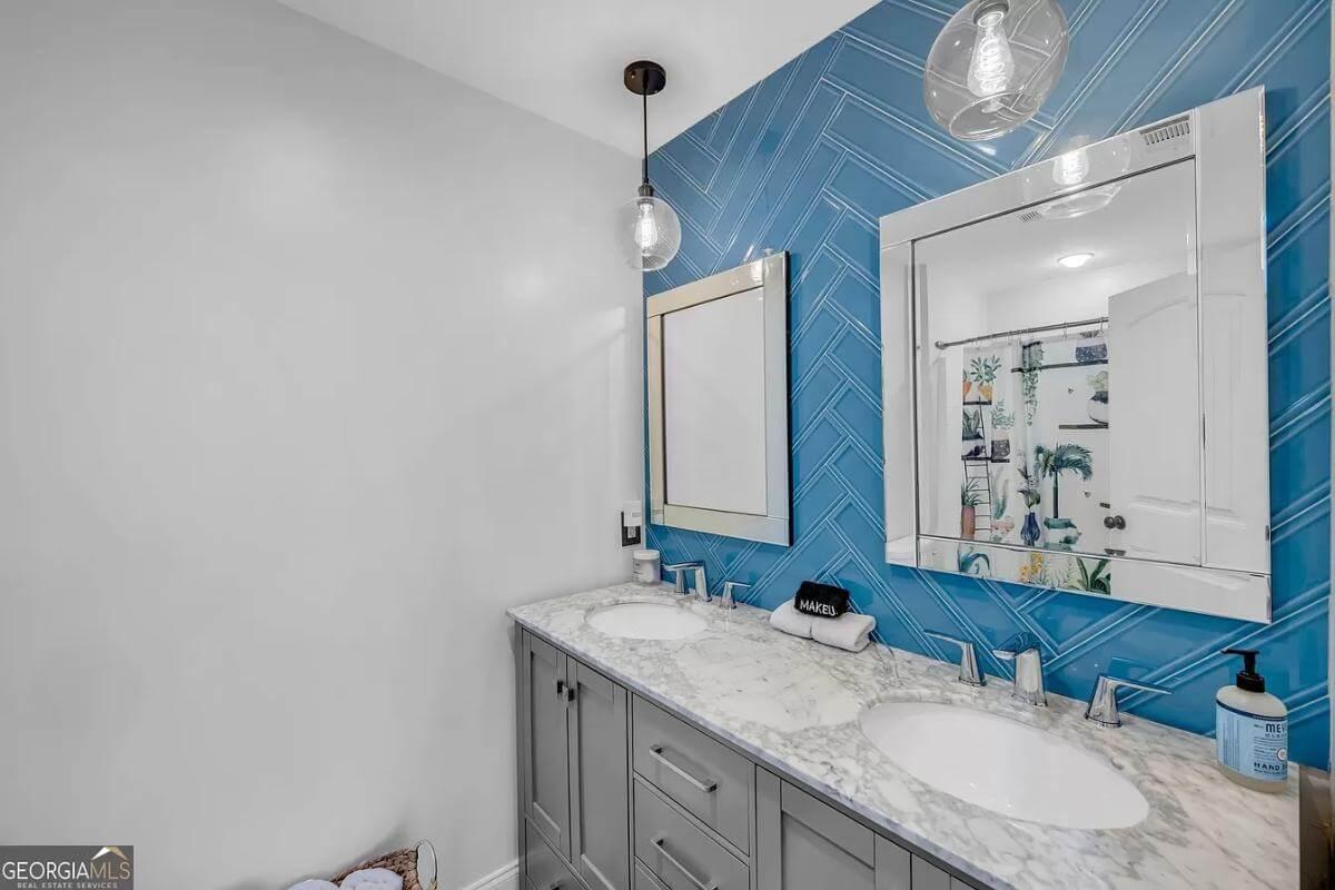 Explore This Fresh Bathroom with Blue Herringbone Tile Accent