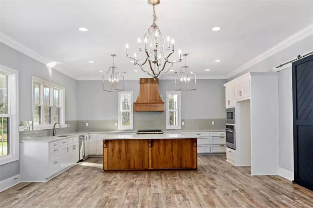 Craftsman Kitchen with Elegant Chandelier and Bold Barn Door