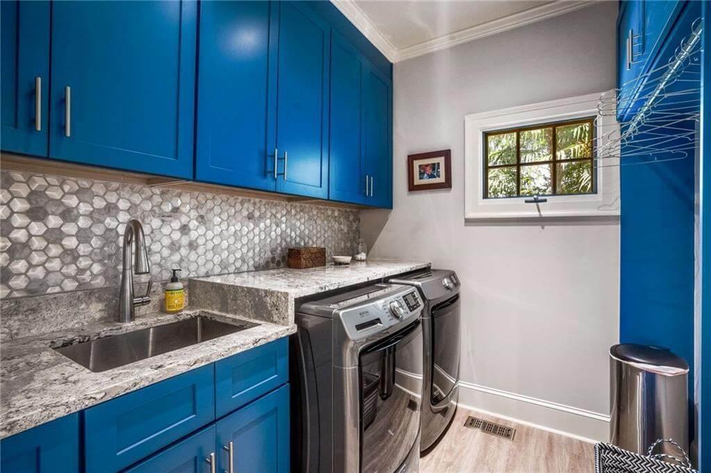Bold Blue Cabinets Define This Stylish Laundry Room