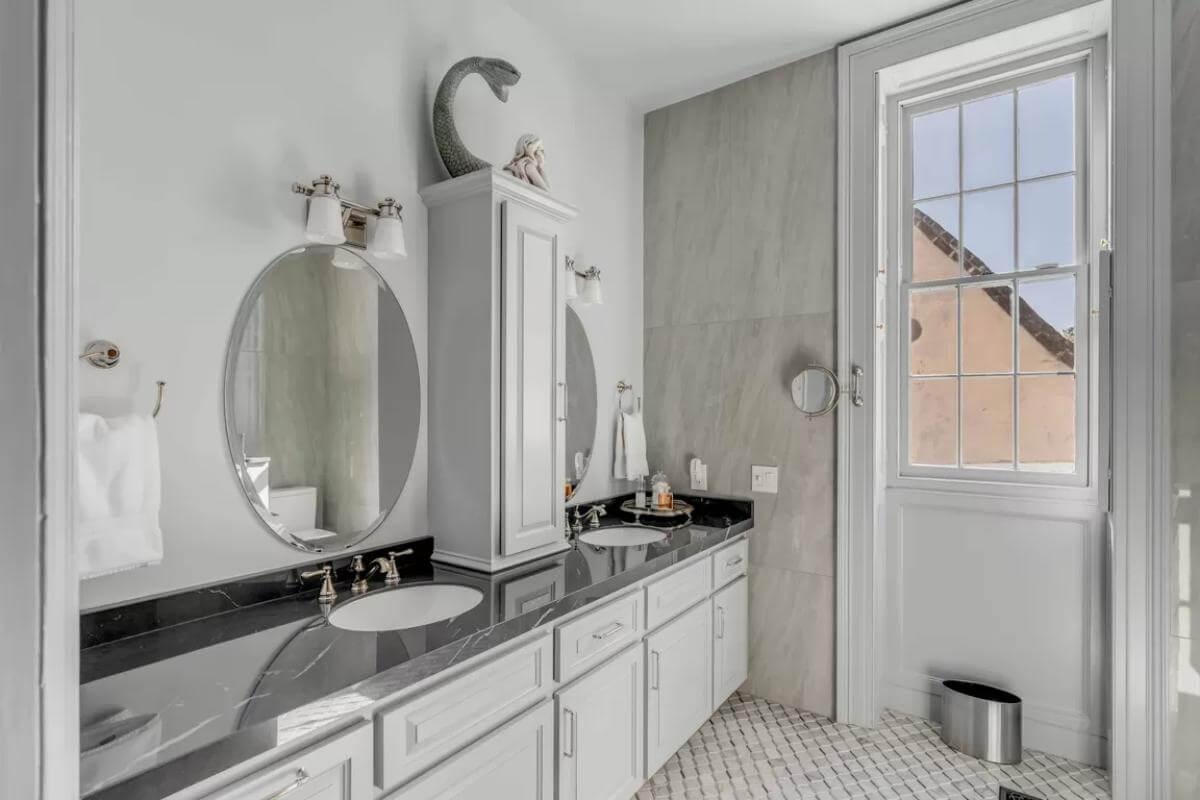 Elegant Bathroom with Dramatic Black Counters and Playful Decor
