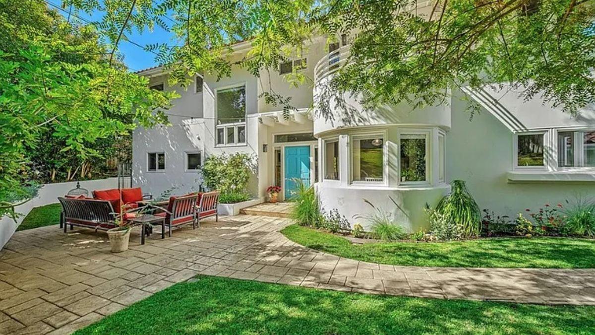 Charming Courtyard with a Vibrant Blue Door and Curved Bay Windows
