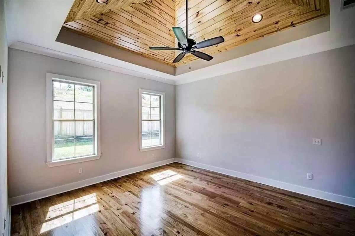 Notice the Wood-Panelled Tray Ceiling in This Simple Bedroom