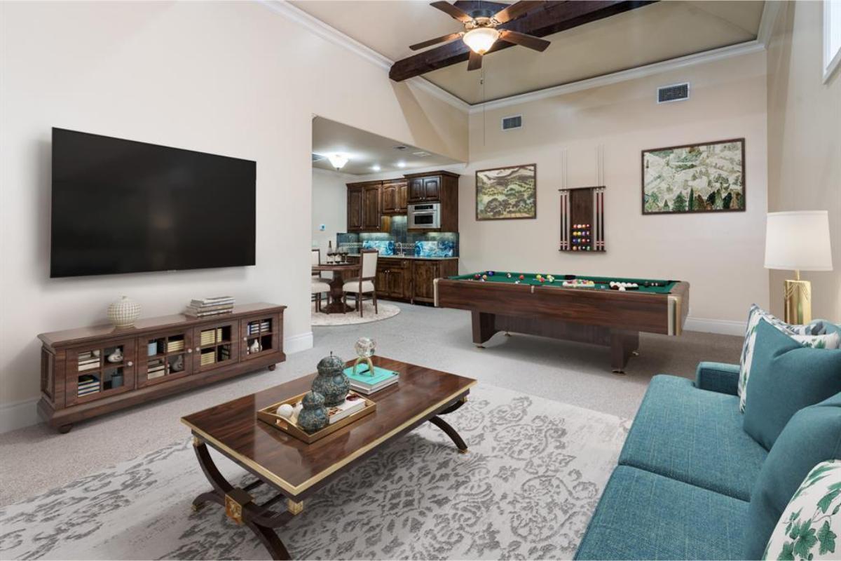 Stylish Game Room Featuring a Pool Table and Vaulted Ceiling