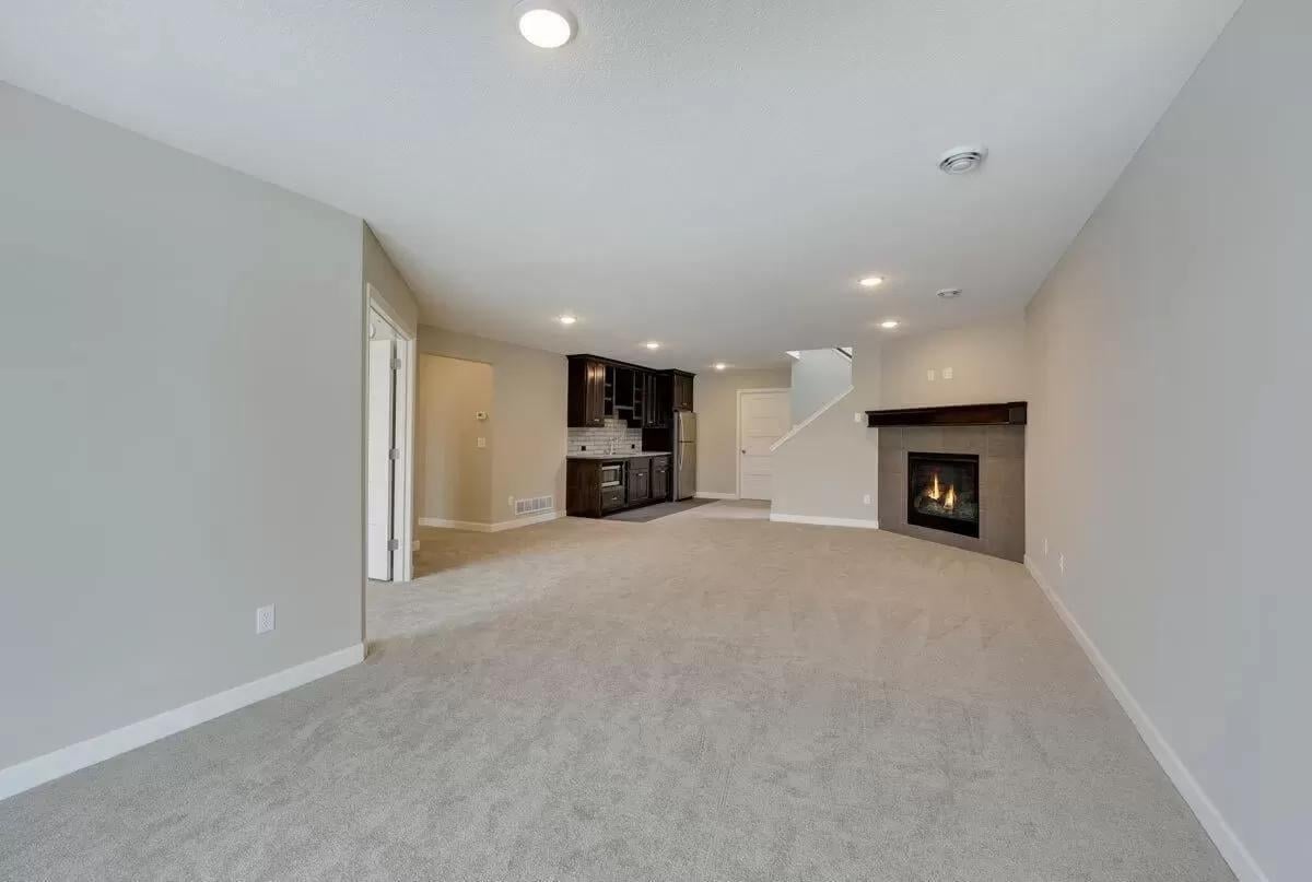 Discover the Cozy Fireplace and Bar Setup in This Spacious Family Room