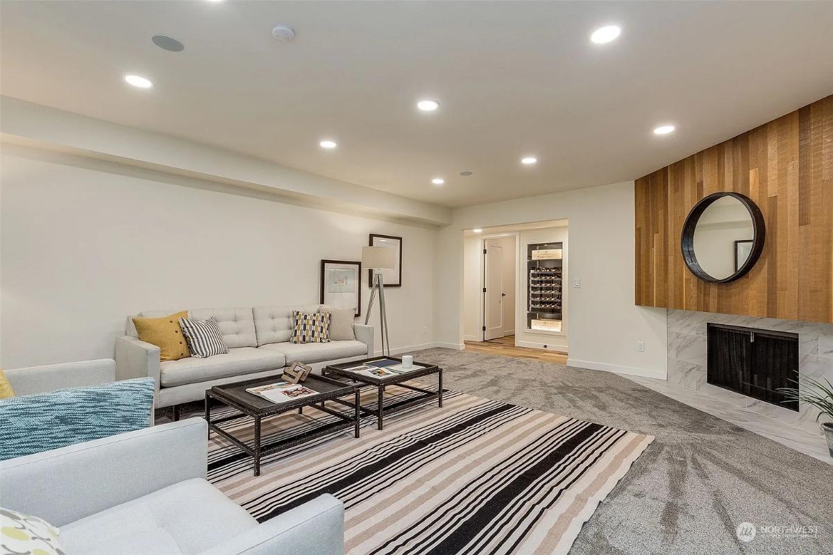 Spot the Sleek Wood Paneling Beside This Modern Fireplace