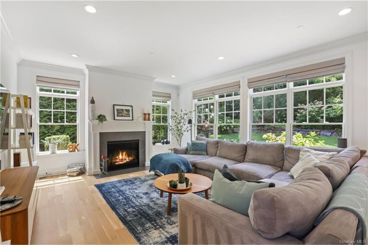Living Room with Large Windows and a Cozy Fireplace at the Heart