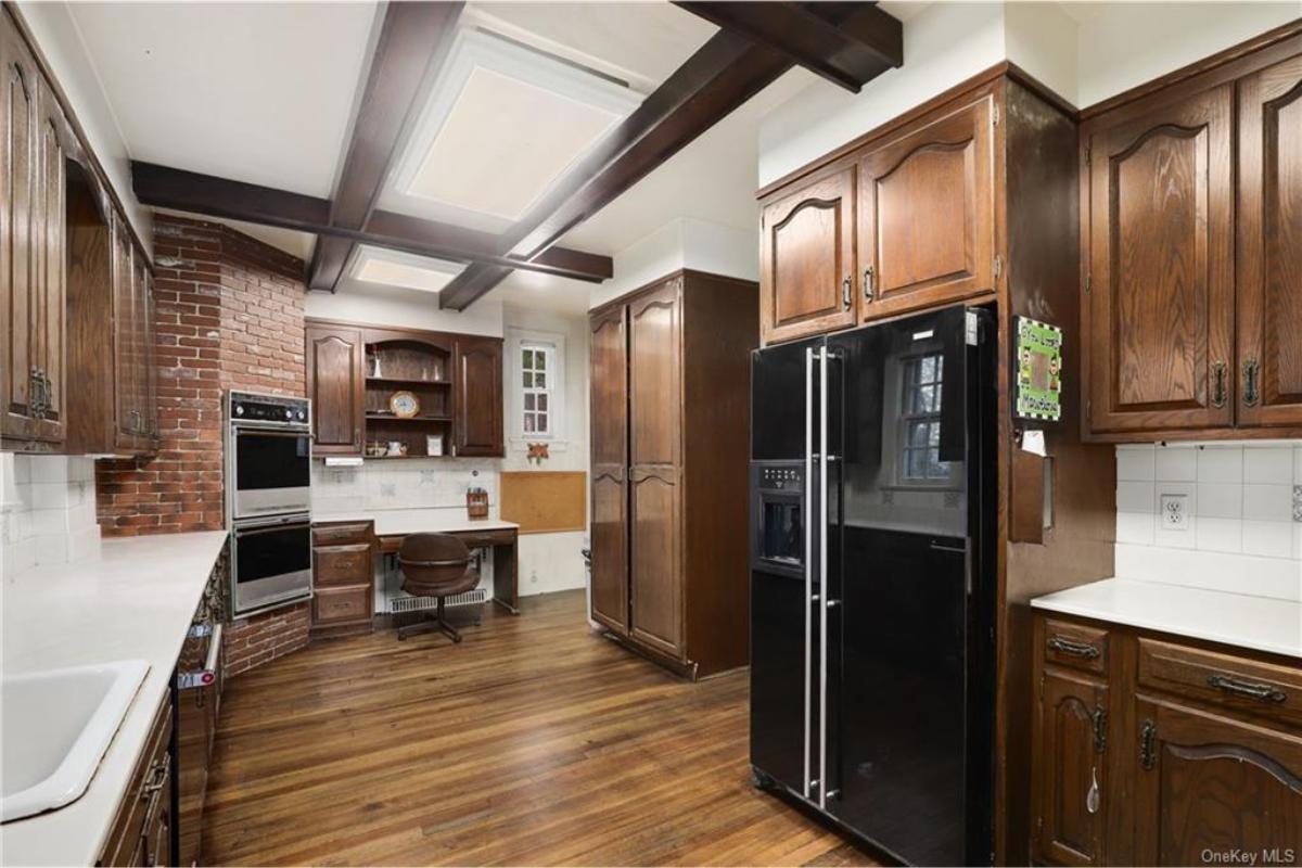 Step into This Retro Kitchen with Exposed Brick and Dark Beamed Ceilings
