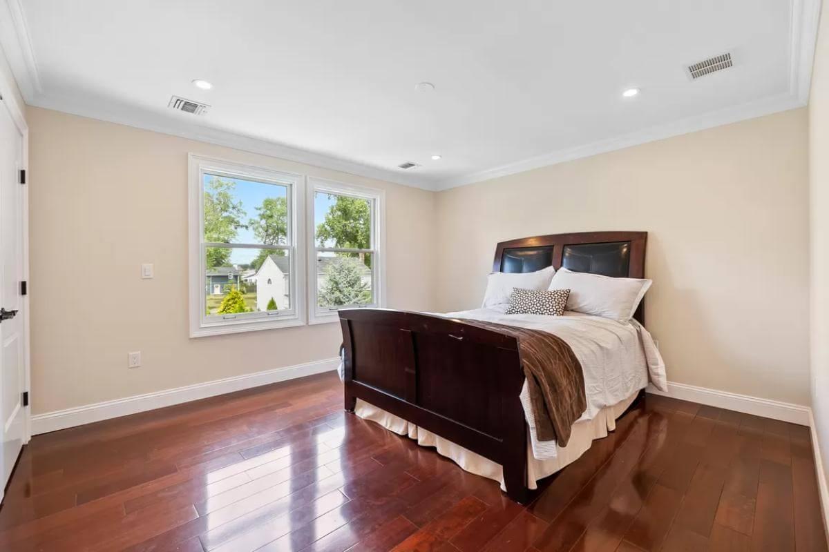 Admire the Sleek Hardwood Floors in This Bright Bedroom
