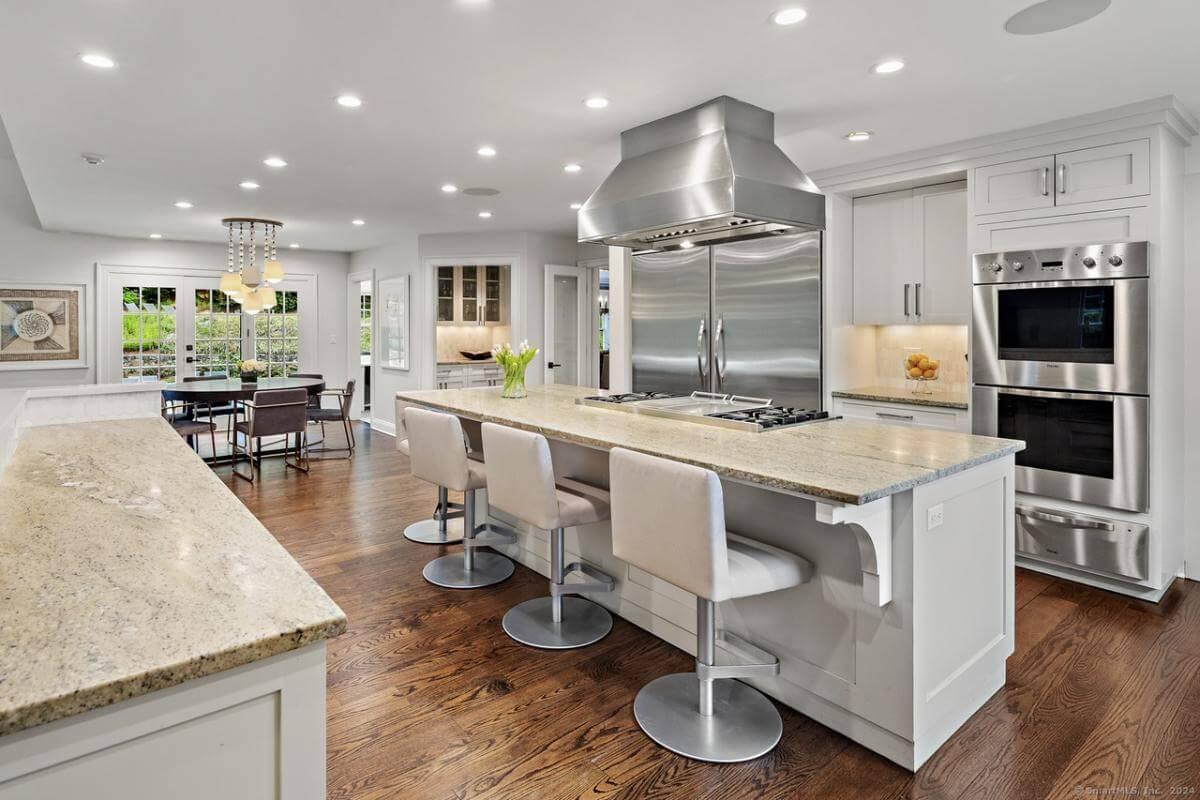 Check Out the Impressively Large Kitchen Island and Stainless Steel Accents