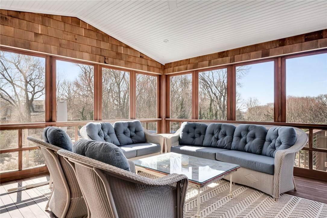 Relax in the Sun-Drenched Comfort of This Screened Porch