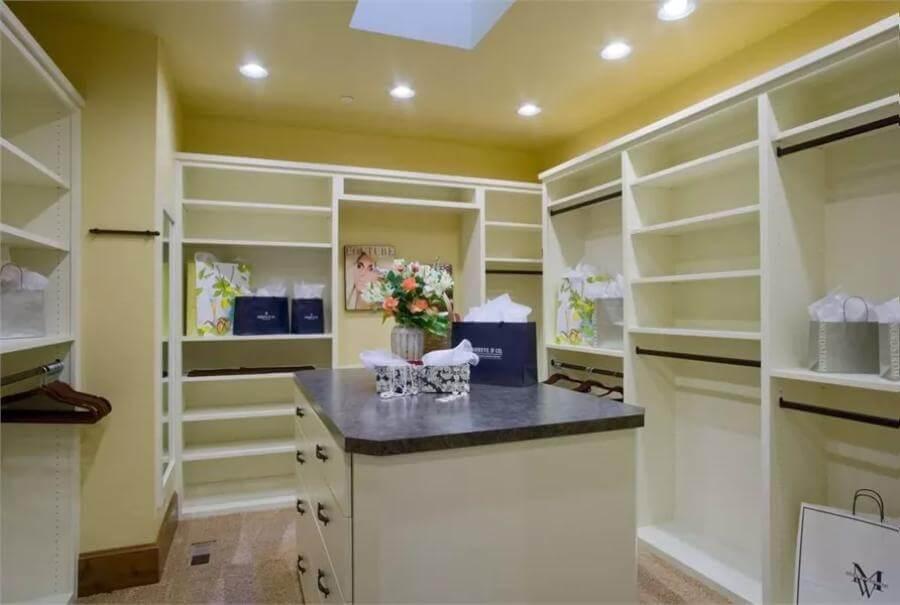 Discover Elegance in Storage: Walk-In Closet with Skylight and Central Island