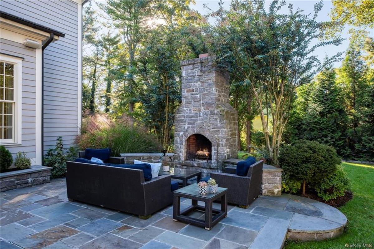 Relax by the Rustic Stone Fireplace in This Outdoor Haven