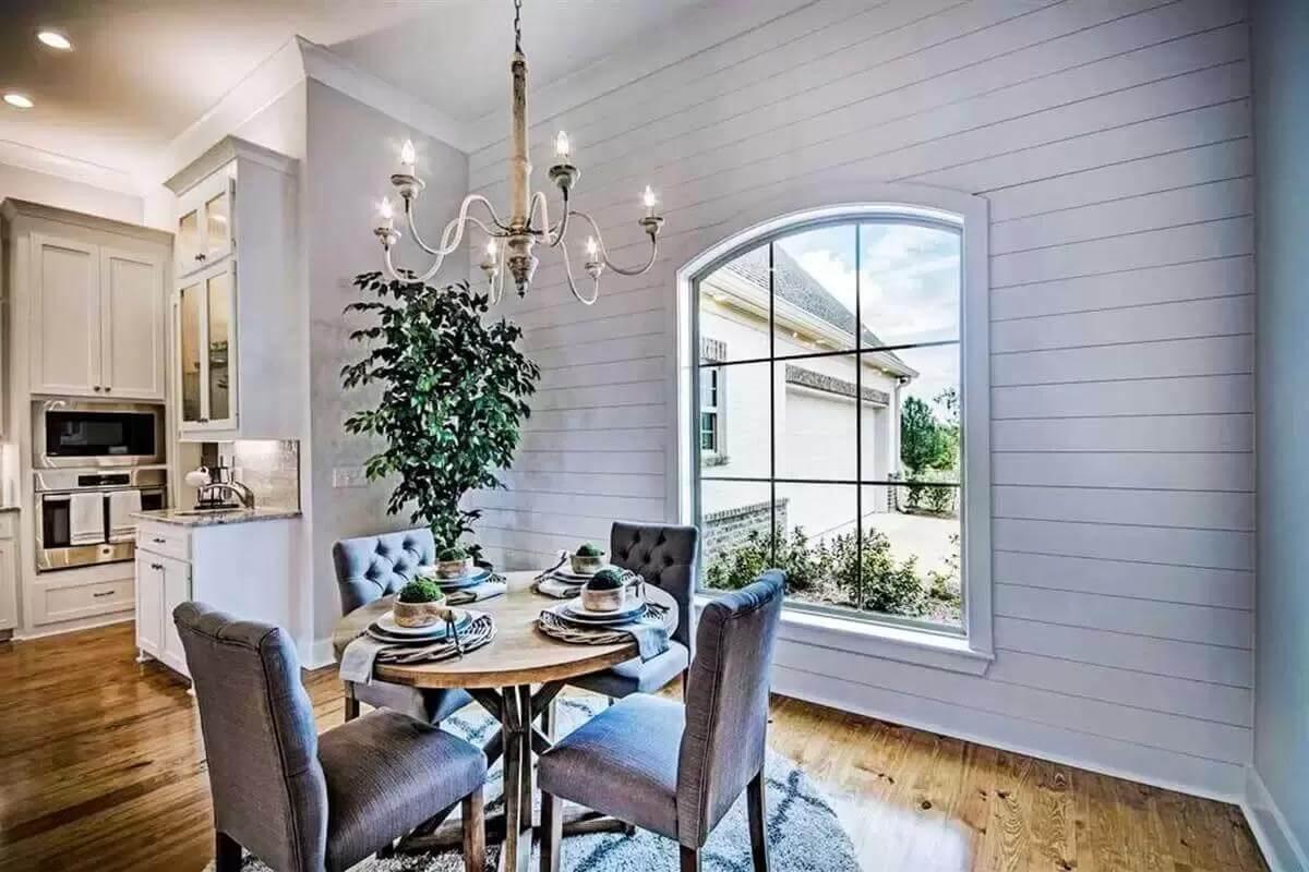 Shiplap Walls and a Picture Window Define This Charming Dining Nook