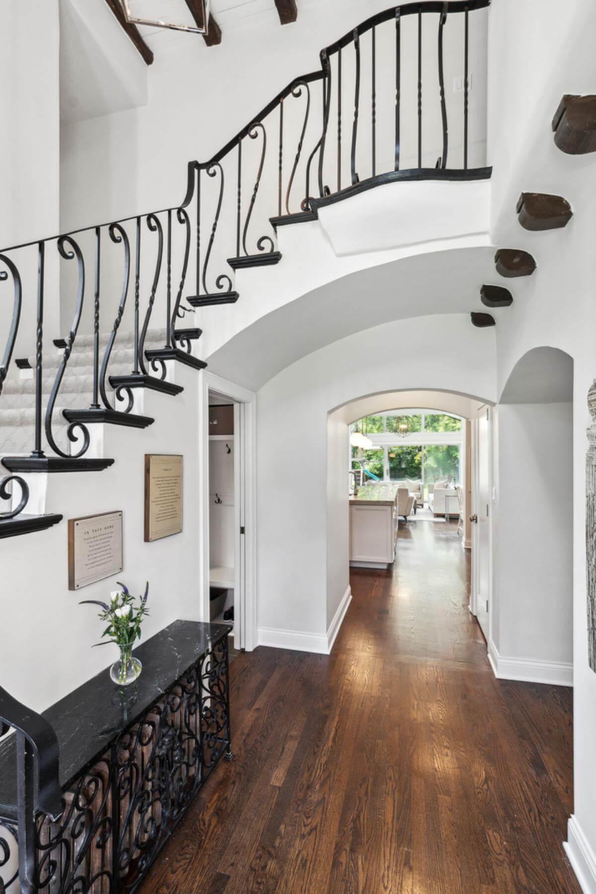 Check Out the Graceful Spiral Staircase with Artful Wrought Iron