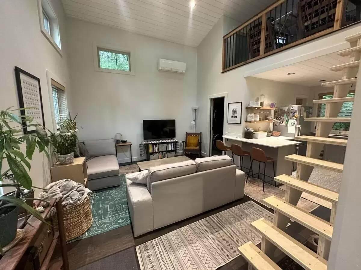 Spot the Airy Loft and Sleek Staircase in This Cozy Living Area