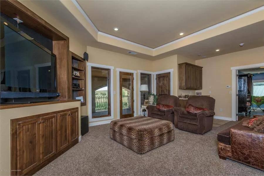 Comfy Living Space With Leopard Print Ottoman and Cozy Recliners
