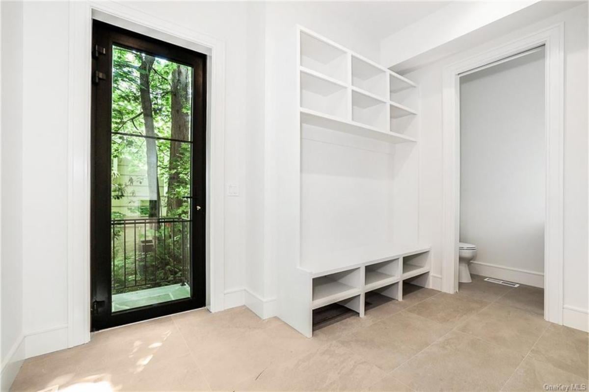 Practical Entryway with Built-In Storage and Forest Views