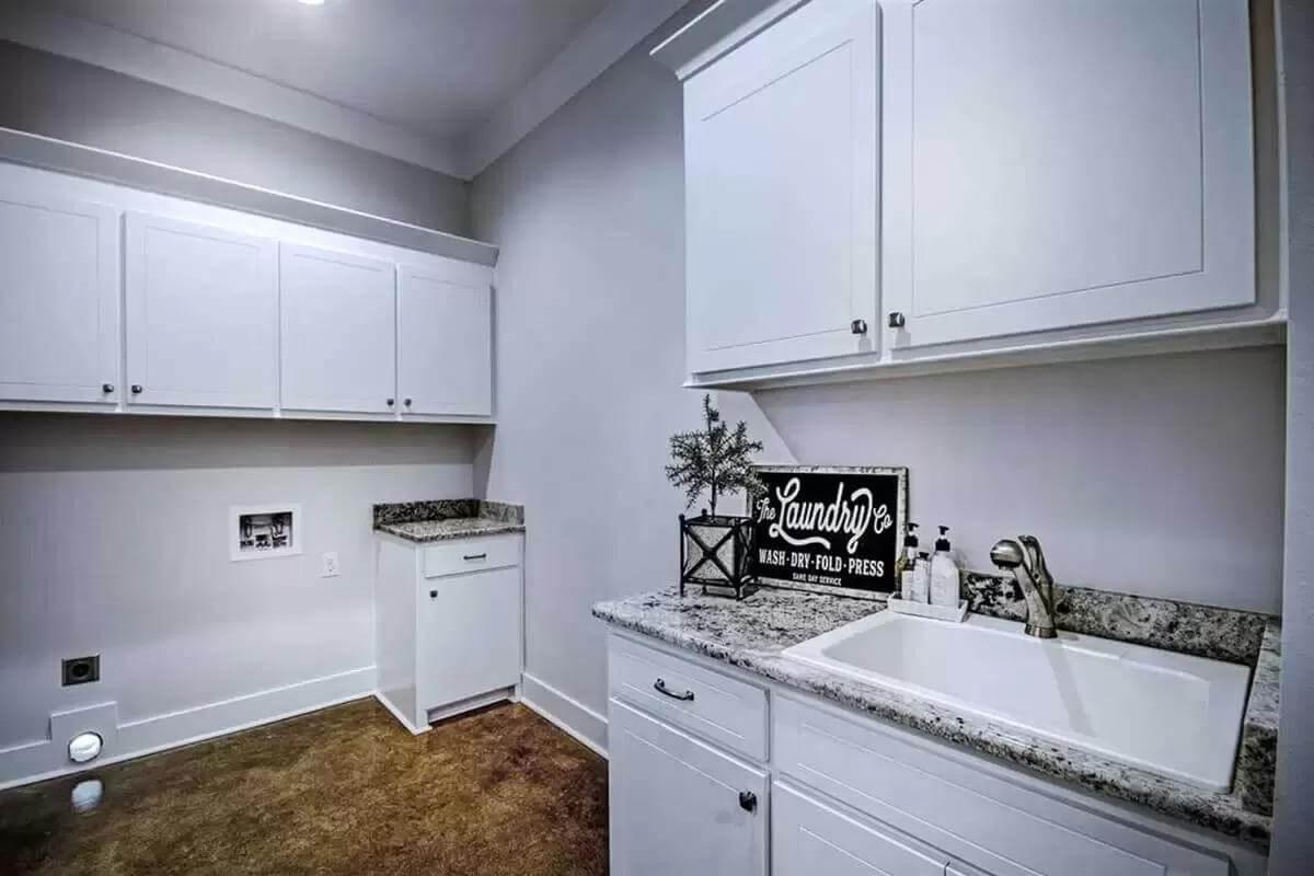 Practical Laundry Room with Granite Accents and Ample Storage