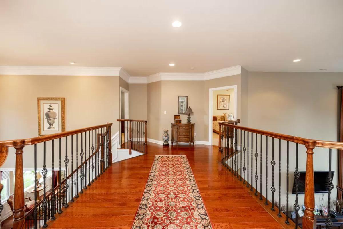 Elegant Upper Landing with Rich Wood Tones and Iron Railings