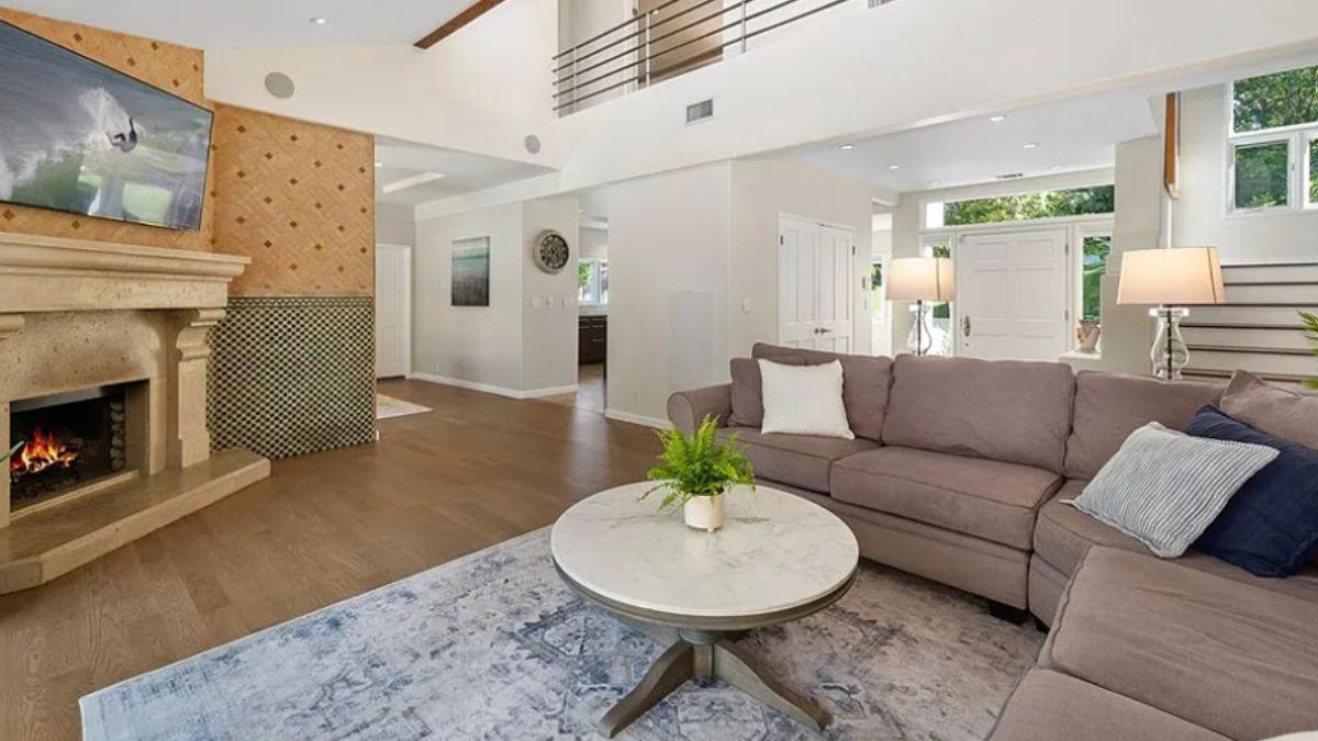 Spacious Living Room with a Grand Fireplace and Modern Accents
