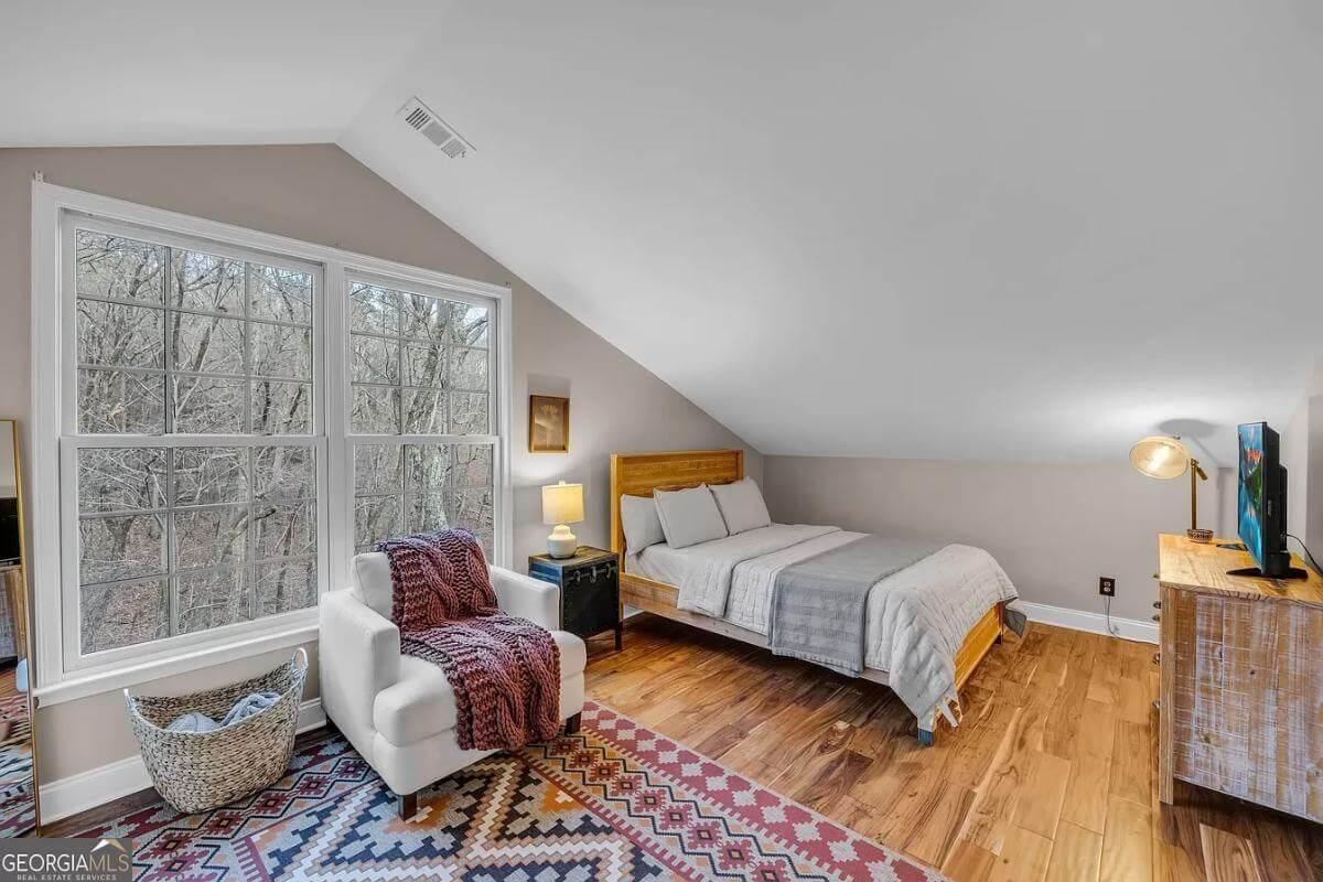 Cozy Bedroom with Sloped Ceiling and Woodland View