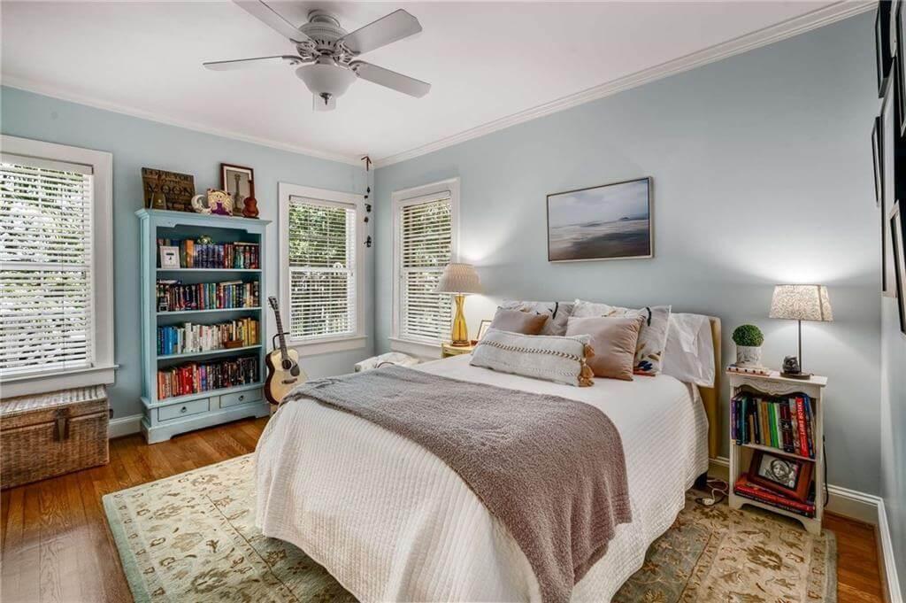 Cozy Bedroom with a Vintage Bookcase and Serene Pastel Walls
