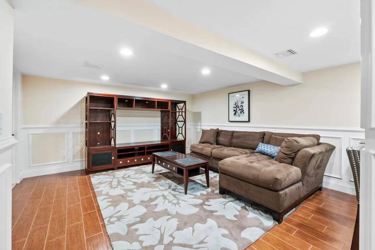 Relax in This Cozy Basement Family Room with Paneled Walls