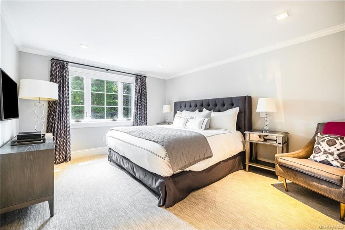 Relax in This Modern Bedroom with Tufted Headboard and Plush Atmosphere