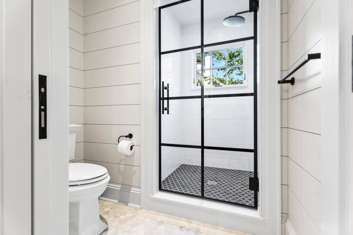 Notice How the Black Framed Shower Adds Modern Flair to This Craftsman Bath