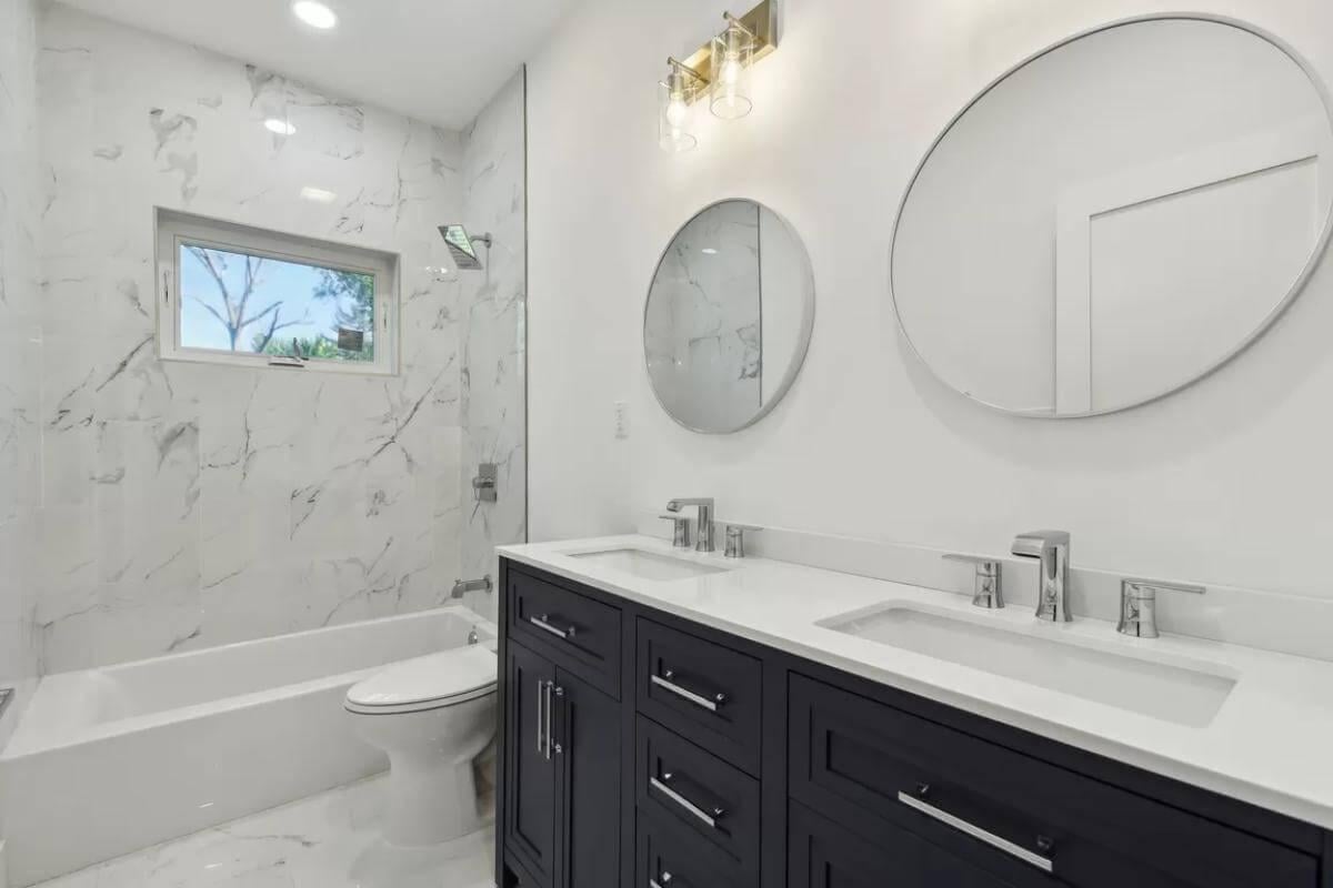 Elegant Bathroom with Double Vanity and Marble Walls
