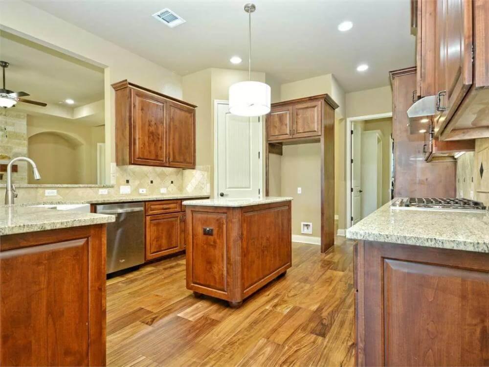 Kitchen Elegance with Rich Wood Cabinetry and Granite Countertops