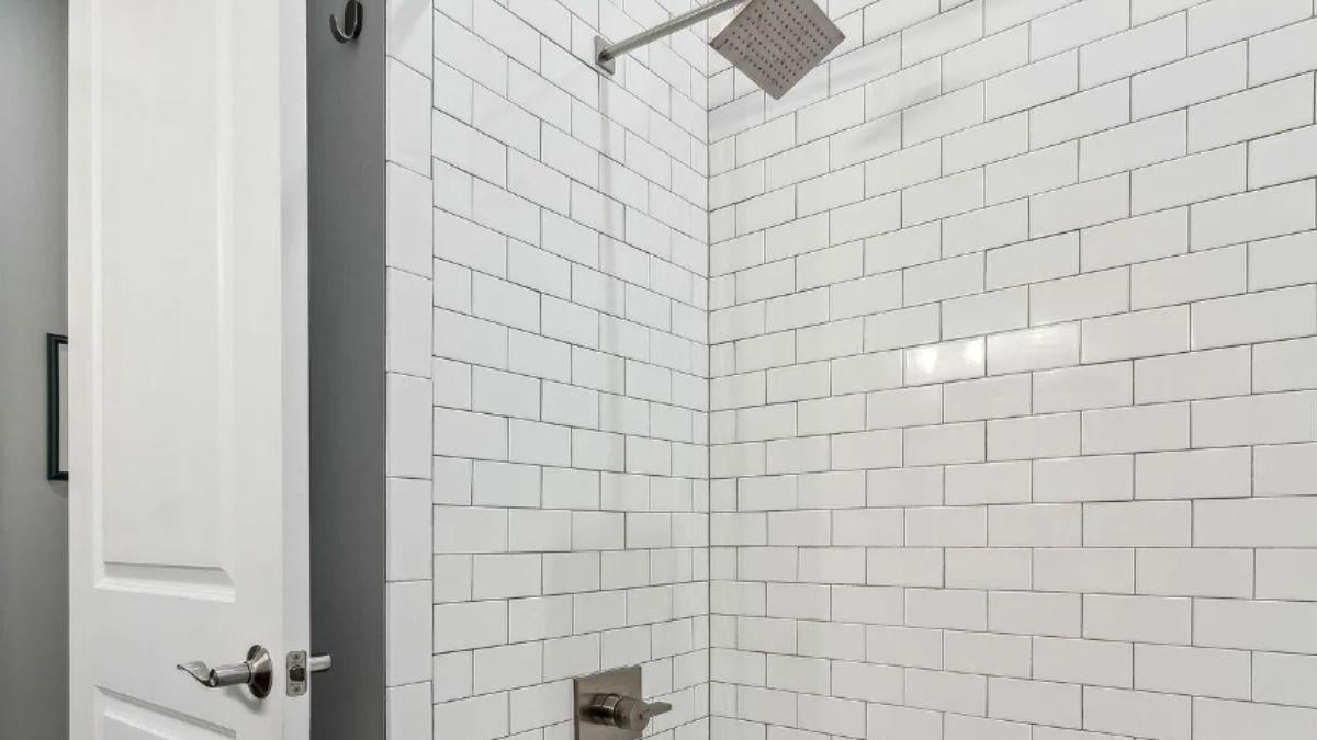 Spotless Subway Tile and a Contemporary Showerhead Create a Crisp Look