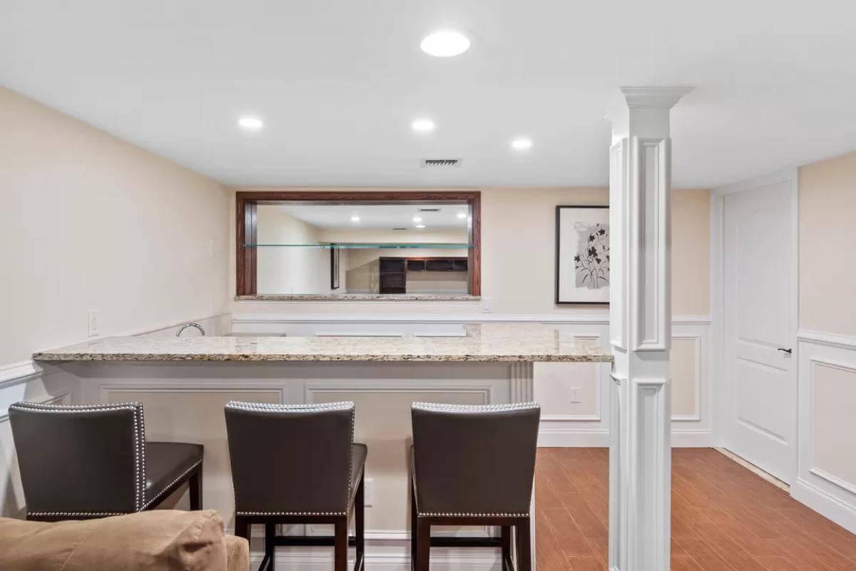 Wow, Check Out the Granite-Topped Bar in This Cozy Basement