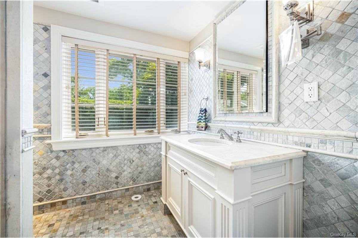 Admire the Textured Charm of This Elegant Bathroom